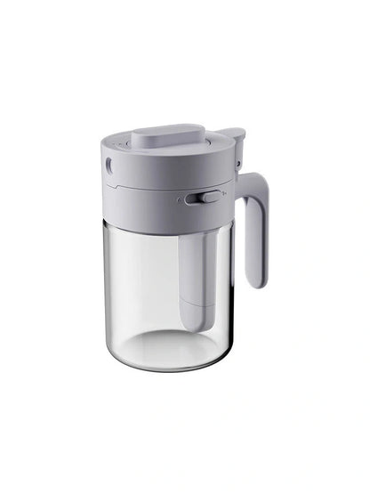 Small glass seasoning jars with lids and spoons in various colors for kitchen organization