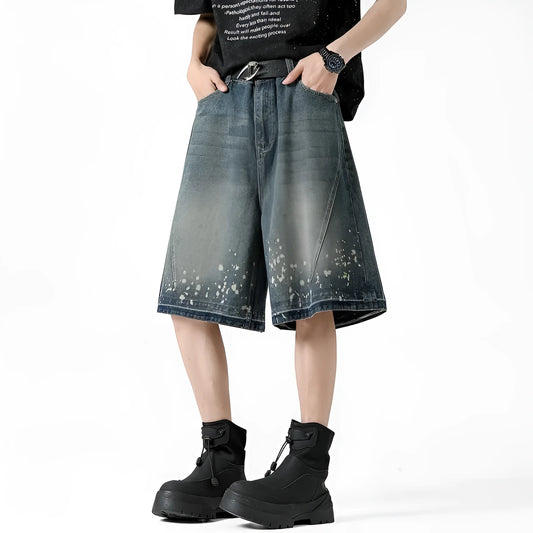 Retro blue denim shorts for men with ripped details and splash ink pattern on a straight cut.