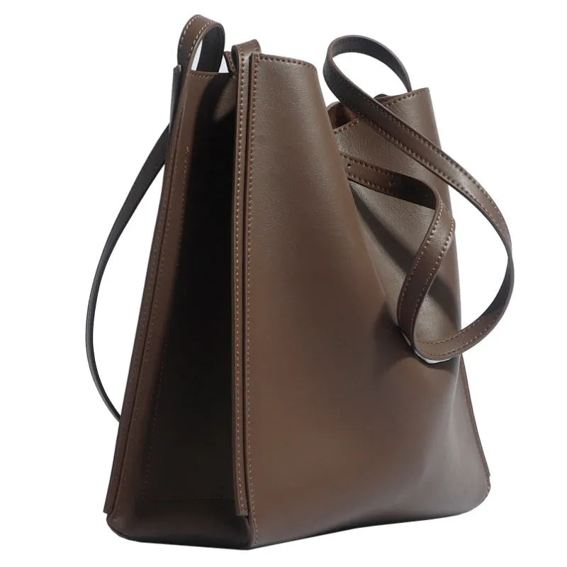 Brown genuine leather women's bucket bag with double shoulder straps showing organisational compartments