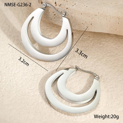 Geometric metallic French earrings in gold or steel colours with round ring design elements