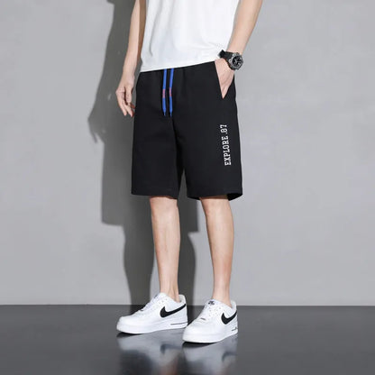 Cotton shorts for teenage boys in black, shown on a hanger, featuring a mid-waist design.