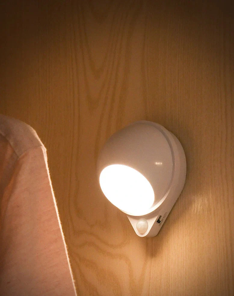 Wireless motion sensor light with USB charging port and adhesive mounting for wall installation