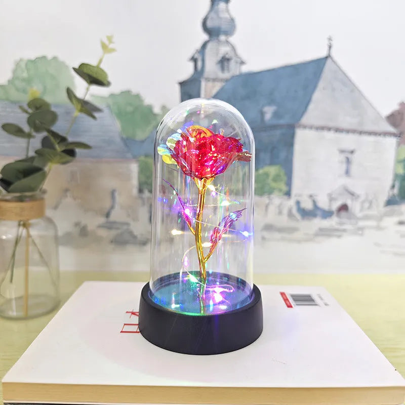 Glass cover small night lamp with plastic flowers, 15cm height, black base, showing colour light options