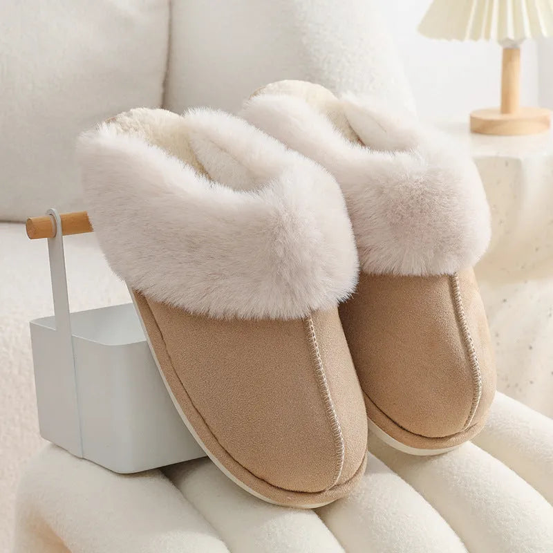 Women's plush indoor slippers in a selection of colours with a fuzzy upper and flat sole.
