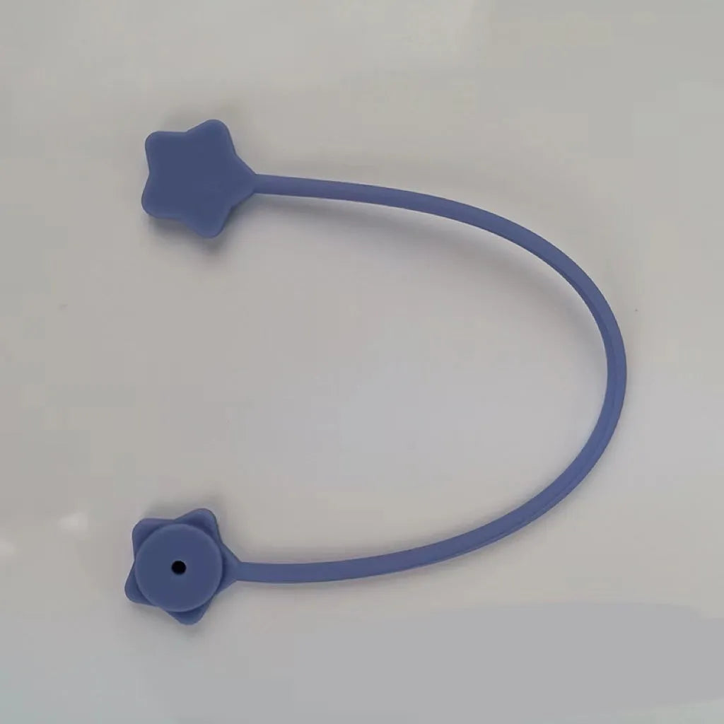 Compact purple silicone cable winder with magnet, shown coiling a white headphone cable.