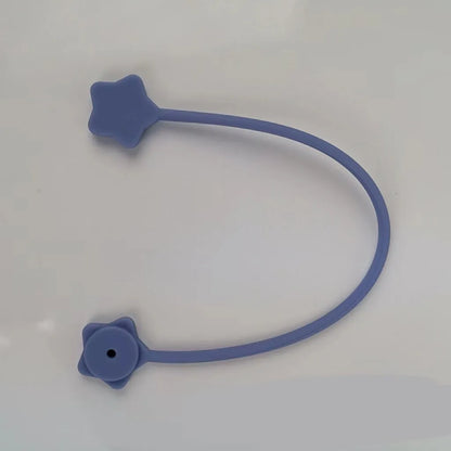Compact purple silicone cable winder with magnet, shown coiling a white headphone cable.