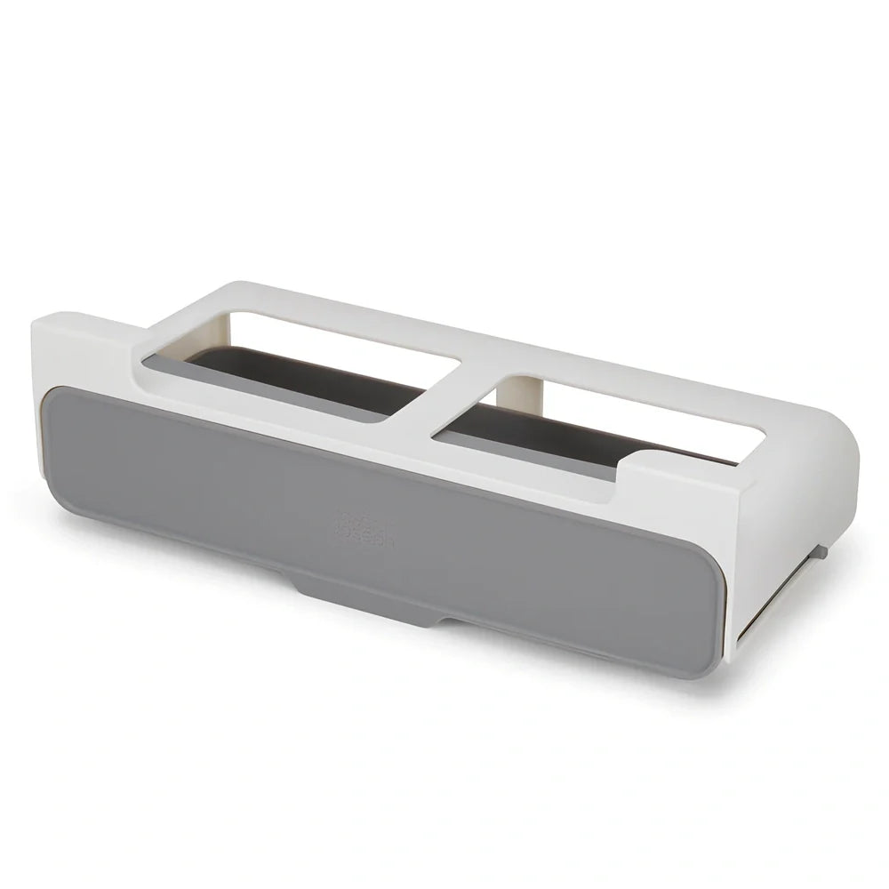 White plastic hanging spice rack with six clear glass bottles, mounted on kitchen door for punch-free storage