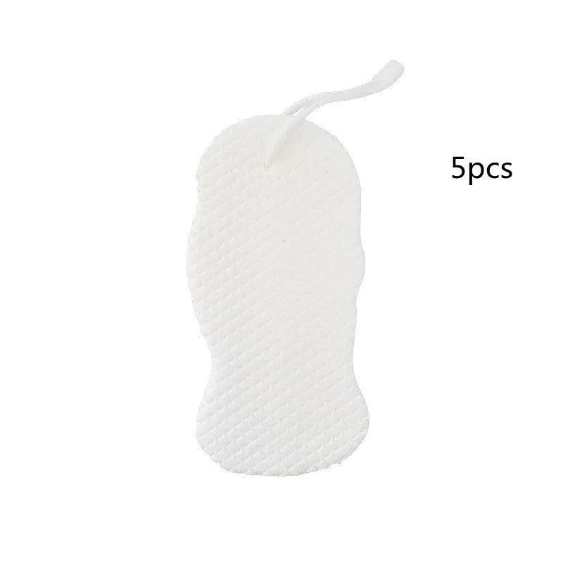 White 3D bath ball sponge with a fish scale exfoliating texture on a blue background.