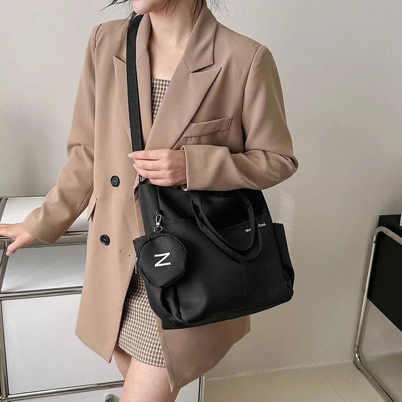 Women's canvas tote messenger bag with waterproof zipper and three shoulder straps in khaki, black, and beige