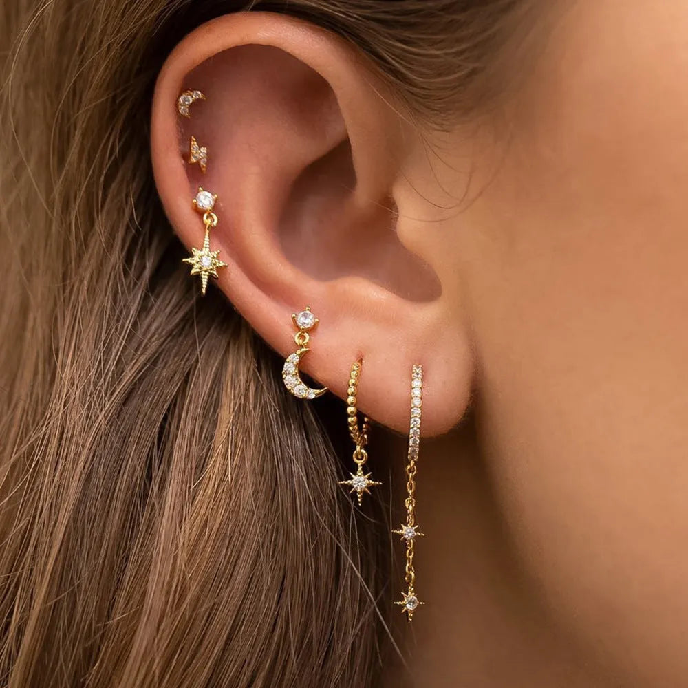 XINGX gold chain tassel earrings set showing six zircon stud earrings with dangling chain elements