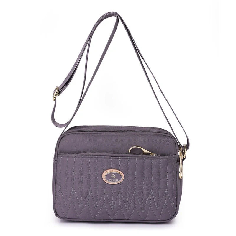 Casual women's crossbody messenger bag in nylon with polyester lining, available in multiple colors