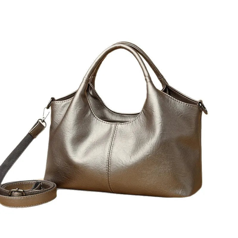 Soft genuine leather women's crossbody bag in beige with large capacity and adjustable strap.
