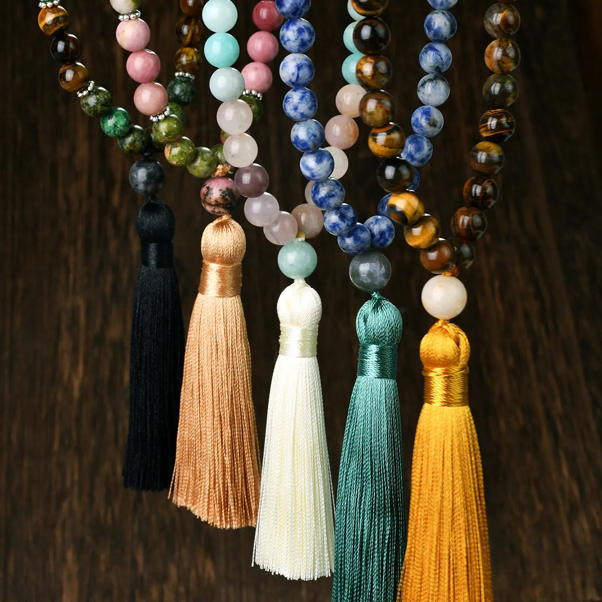 Long beaded necklace with geometric pendant and natural stone tassels in green aventurine.