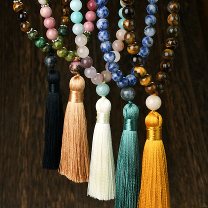 Long beaded necklace with geometric pendant and natural stone tassels in green aventurine.