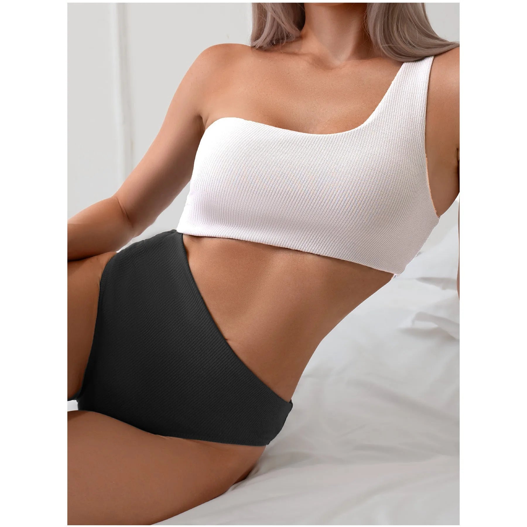 Women's light grey one-shoulder one-piece swimsuit made from polyester fabric.