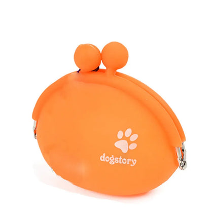 Yellow silicone dog training treat pouch with a black hook and loop waist strap, shown with dog biscuits.