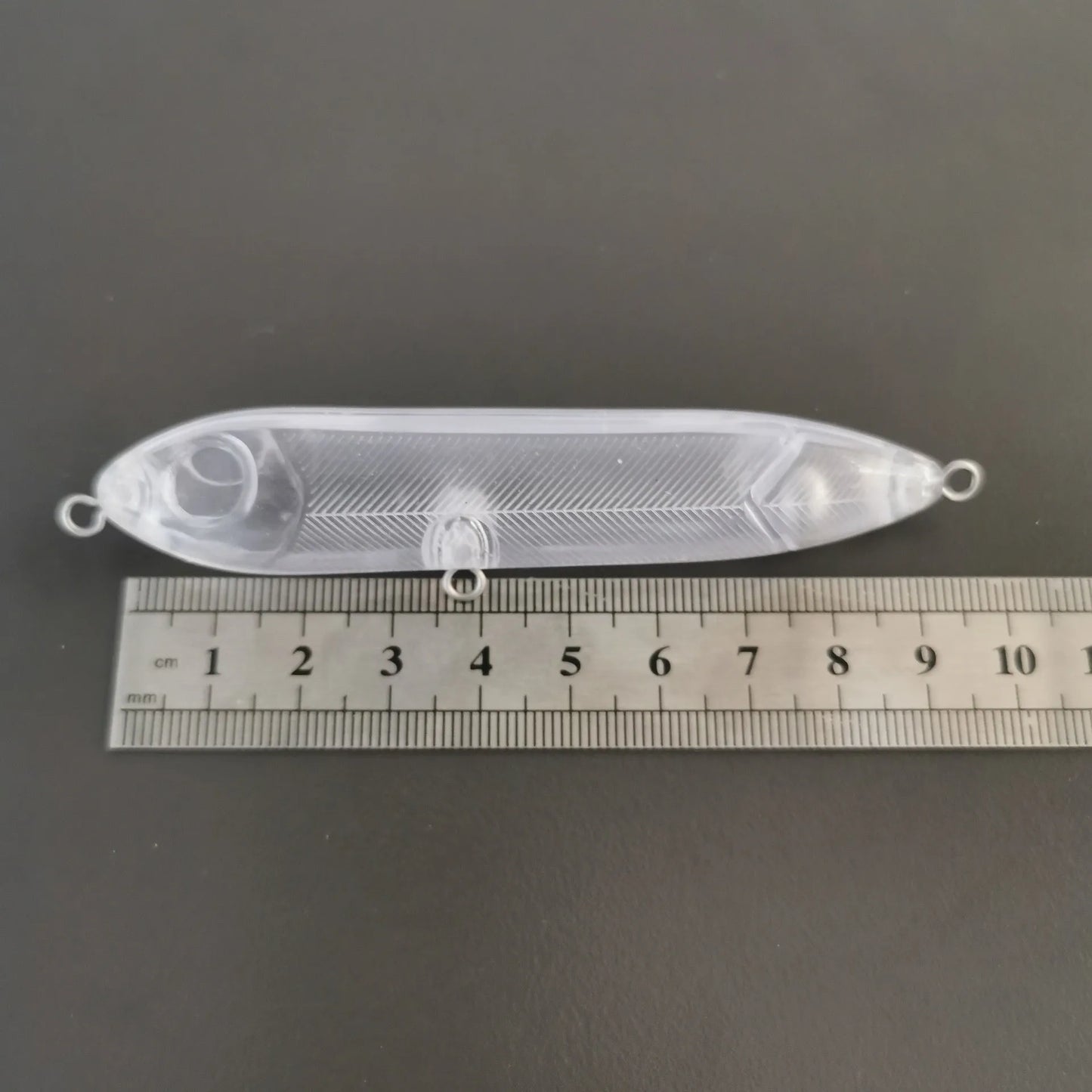 Transparent 9.5cm long DIY fishing lure blank shell made of ABS plastic with a visible 7mm eye hole.