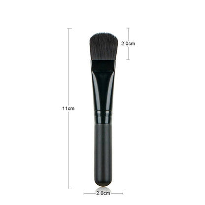 Wooden handle facial treatment brush, 12cm total length, 2cm artificial fibre bristles, black or wood colour.