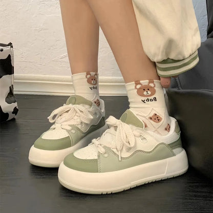 Green women's casual flat shoes with round toe and PU mesh upper on a white background.