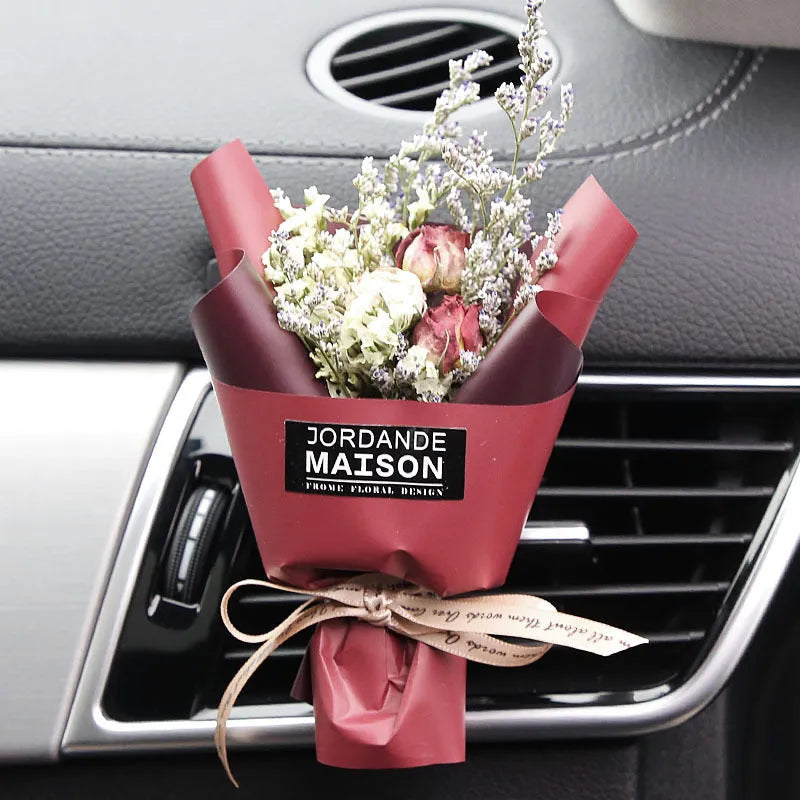 Mini dried flower bouquet mounted in car air vent for decorative aromatherapy