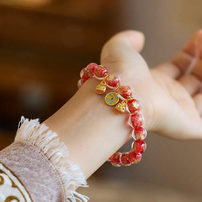 Handmade national style bracelet with coloured glaze swallowing gold beast charm on beaded band.