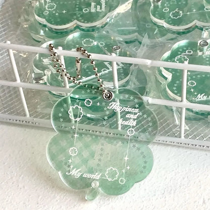 Blue, green, and mint green four-leaf clover acrylic pendant keychain on a metal ring.