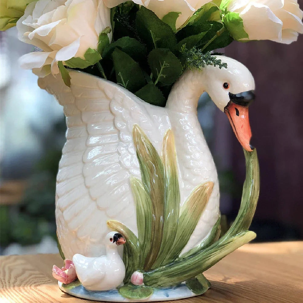 Ceramic vase with embossed swan design measuring 24.1cm length 15.2cm width 20cm height