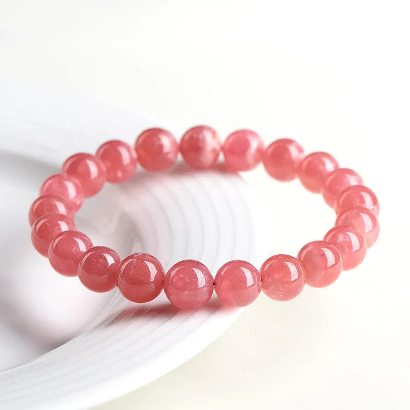Women's geometric crystal bracelet with red rhodochrosite stones and longevity lock clasp, showing bead size options
