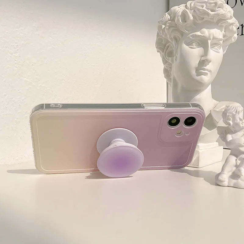 Yellow to purple gradient silicone iPhone case with a pop-out kickstand deployed.