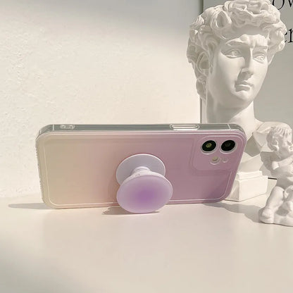 Yellow to purple gradient silicone iPhone case with a pop-out kickstand deployed.