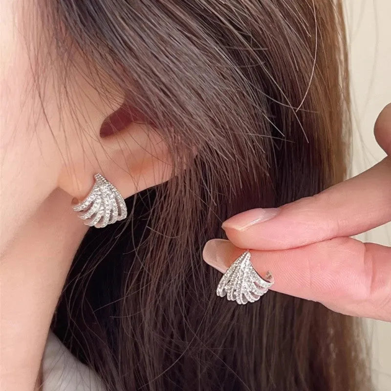 Geometric line design earrings with platinum electroplating on zircon, showing symmetrical patterns and clean architectural lines
