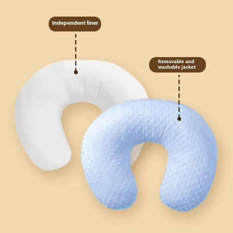Nursing pillow with integrated 15cm raised barrier to prevent milk spills during breastfeeding, shown with removable pillowcase