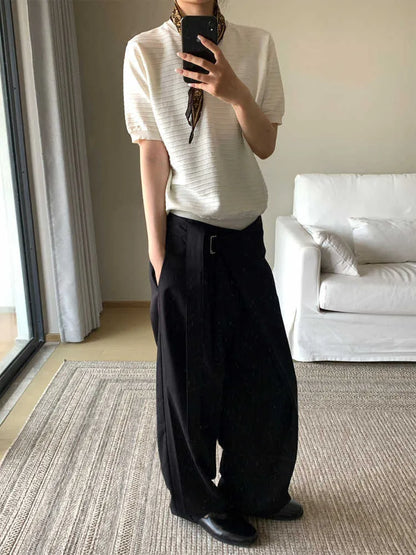Black straight-leg trousers with a single front pleat and adjustable mid-waist on a hanger.