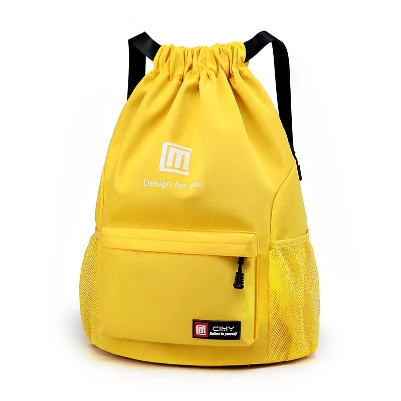 Large bucket-shaped travel backpack in blue with drawstring closure and soft black shoulder straps.
