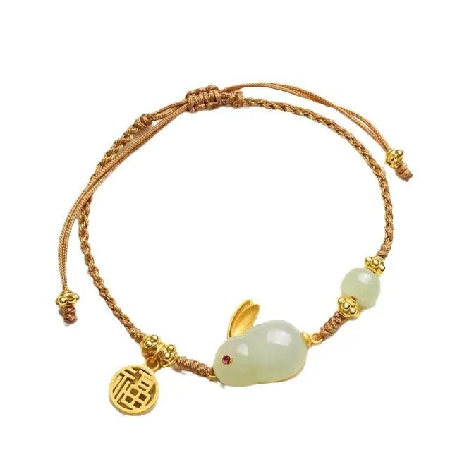 Hetian jade geometric rabbit charm on a yellow string bracelet for women.
