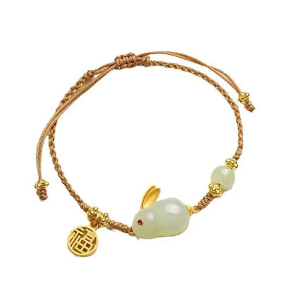 Hetian jade geometric rabbit charm on a yellow string bracelet for women.