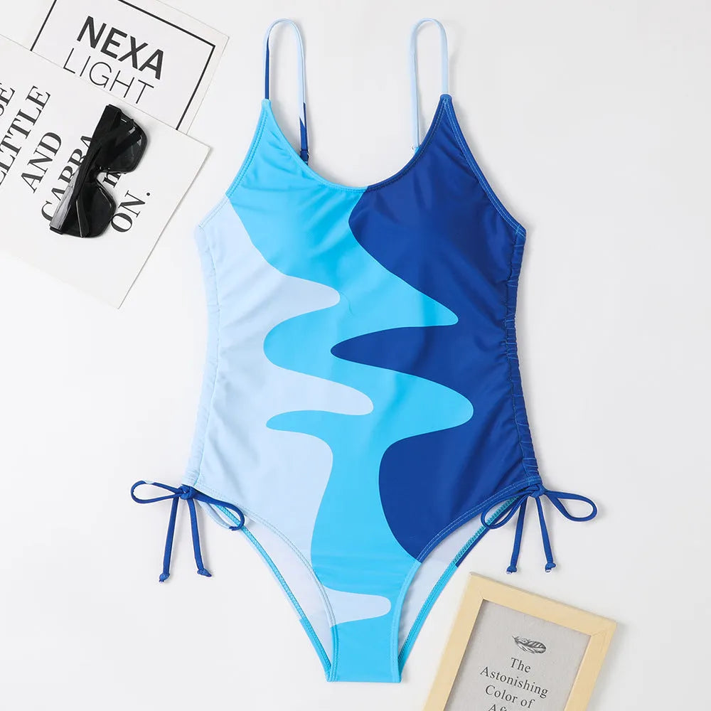 A blue one-piece swimsuit for women, showing sleeveless and backless design on a mannequin.