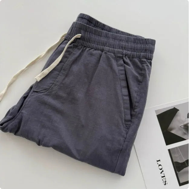 Men's loose straight casual pants with drawstring waist in navy blue colour, showing relaxed fit and straight leg design