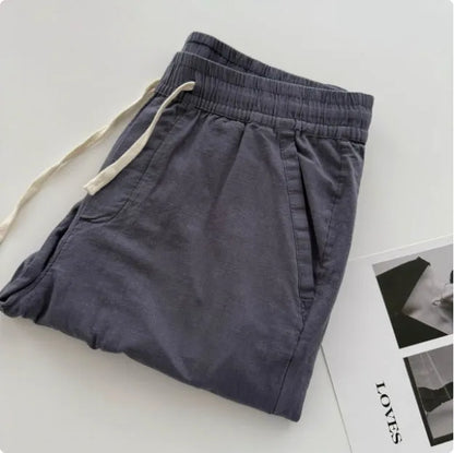 Men's loose straight casual pants with drawstring waist in navy blue colour, showing relaxed fit and straight leg design