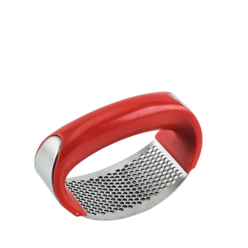 Stainless steel garlic press with ergonomic handle in kitchen setting