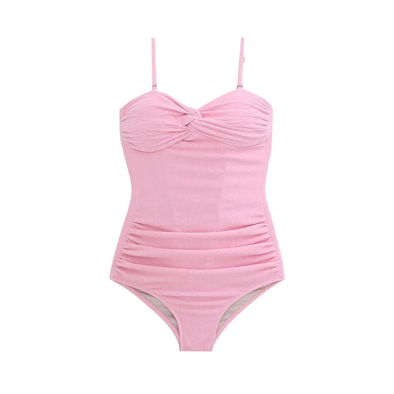 Women's black suspender-style one-piece swimsuit with high waist and push-up lining.