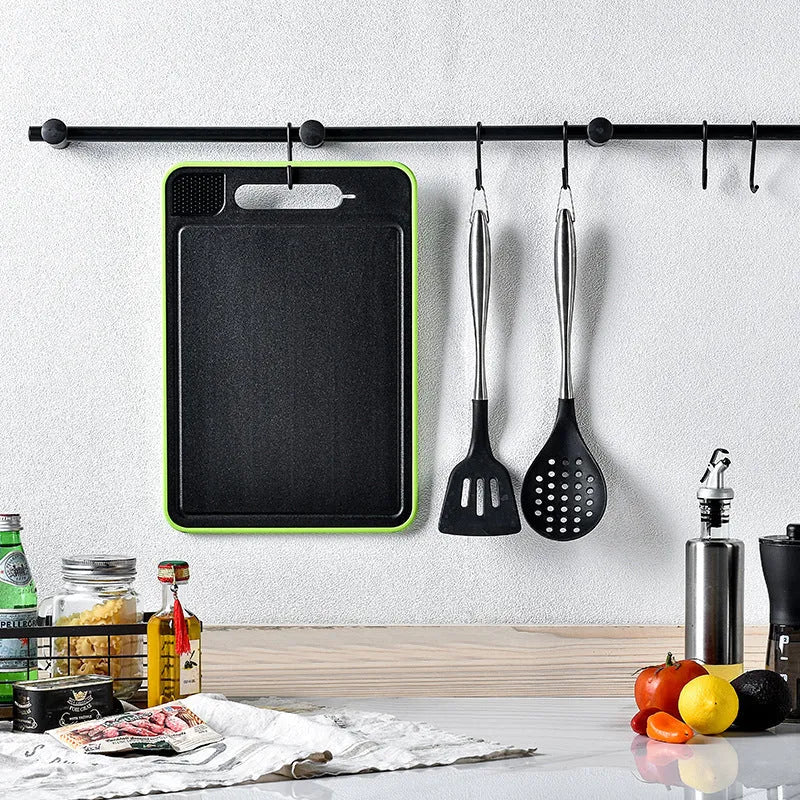 Grey square aluminium cutting board with double-sided design showing grinding teeth and knife sharpener