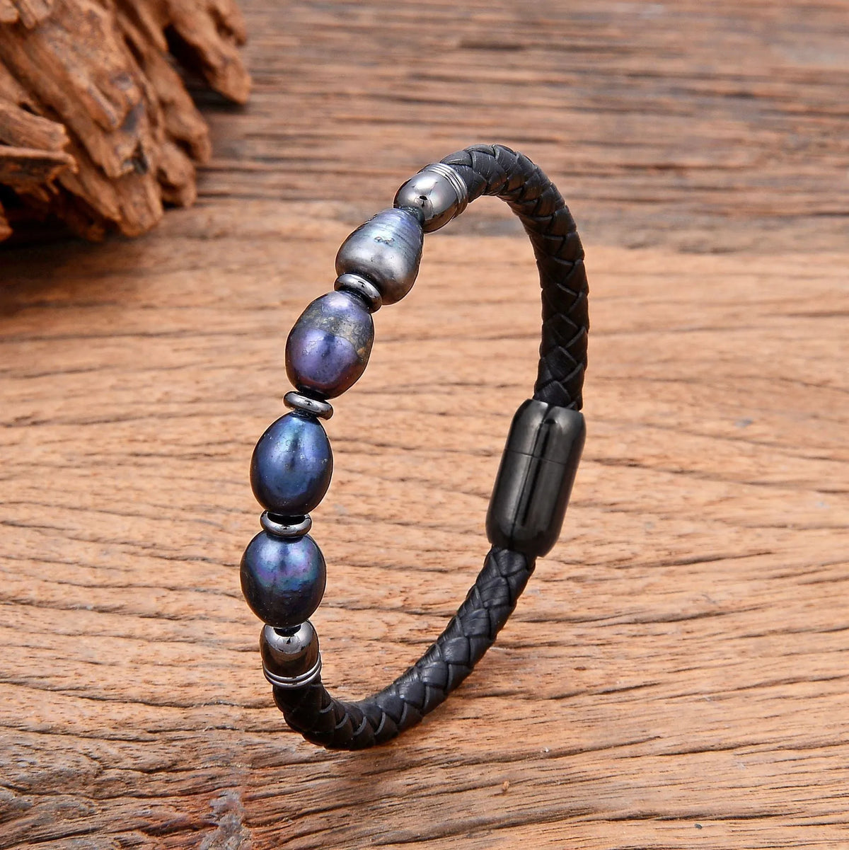 Handmade irregular shape pearl bracelet on a leather cord, showing adjustable loop closure.