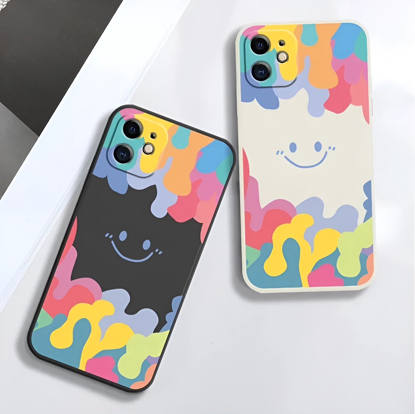 White silicone iPhone case with rainbow smiley face pattern and attached lanyard