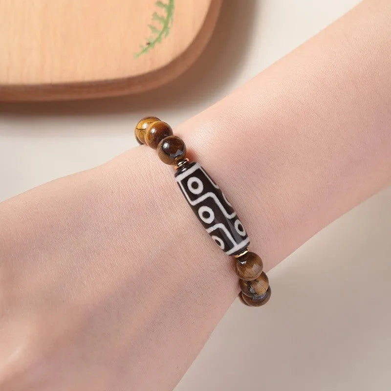 Buddha rosary bracelet in unisex ethnic style featuring a single circle of tigereye Dzi beads. Available in four practical sizes: 6mm, 8mm, 10mm, and 12mm beads for adjustable wrist fit. A minimalist spiritual accessory or simple personal ornament.