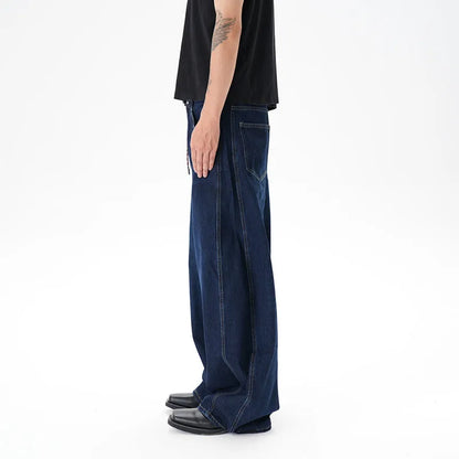 Woman wearing dark blue distressed wide leg denim jeans in a casual setting.