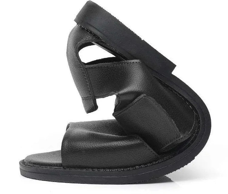 Men's brown leather Roman-style sandals with an open toe and a textured rubber sole on a wooden surface.