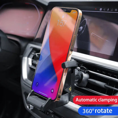 Gold car air vent phone holder with 360-degree rotation and silicone padding mounted on vehicle vent