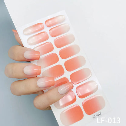 Sheet of 16 small design nail art stickers including cross, rose, tulip and marble patterns.