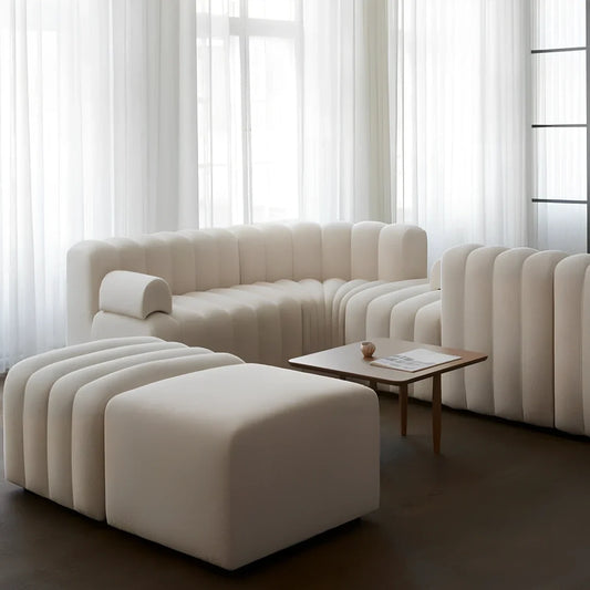 Off-white curved modular sofa with fleece fabric in corner configuration showing multiple connected pieces